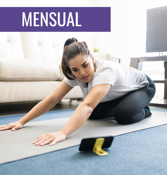 Beautiful Young Woman Sitting On Exercise Mat At Home Learning Y